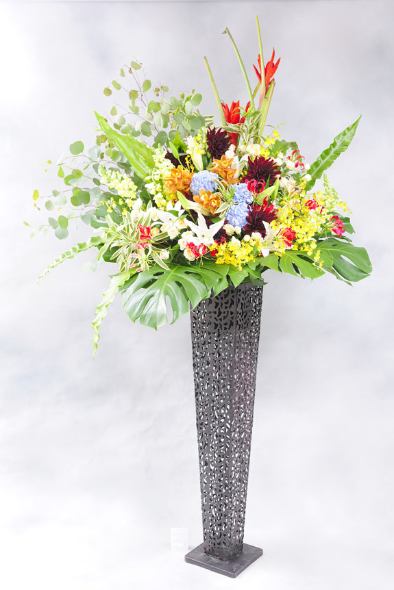 <p>鮮やかな稀少花材と黒ブリキスタンドで仕立てたスタイリッシュな最高級黒ブリキ一段スタンド花。</p>
