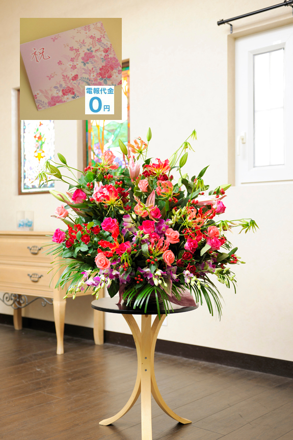 大型サイズのアレンジメントフラワーＬサイズをピンク・赤系の花を中心にお仕立て致します。高さ約90cmにもなりますので存在感を大いに感じさせてくれるフラワーギフトとなる事でしょう。、ピンク系や赤系はゴージャスでエレガントなお仕立です。