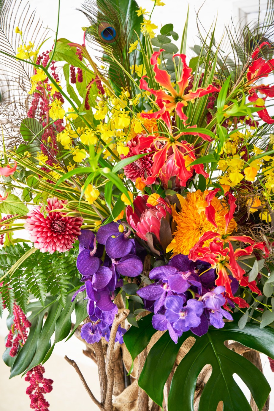 <p>お花はカラフルですが孔雀の羽とあわせてどこか妖艶な魅力があります。生花の種類やお色はおまかせいただいており、ご指定できません。</p>